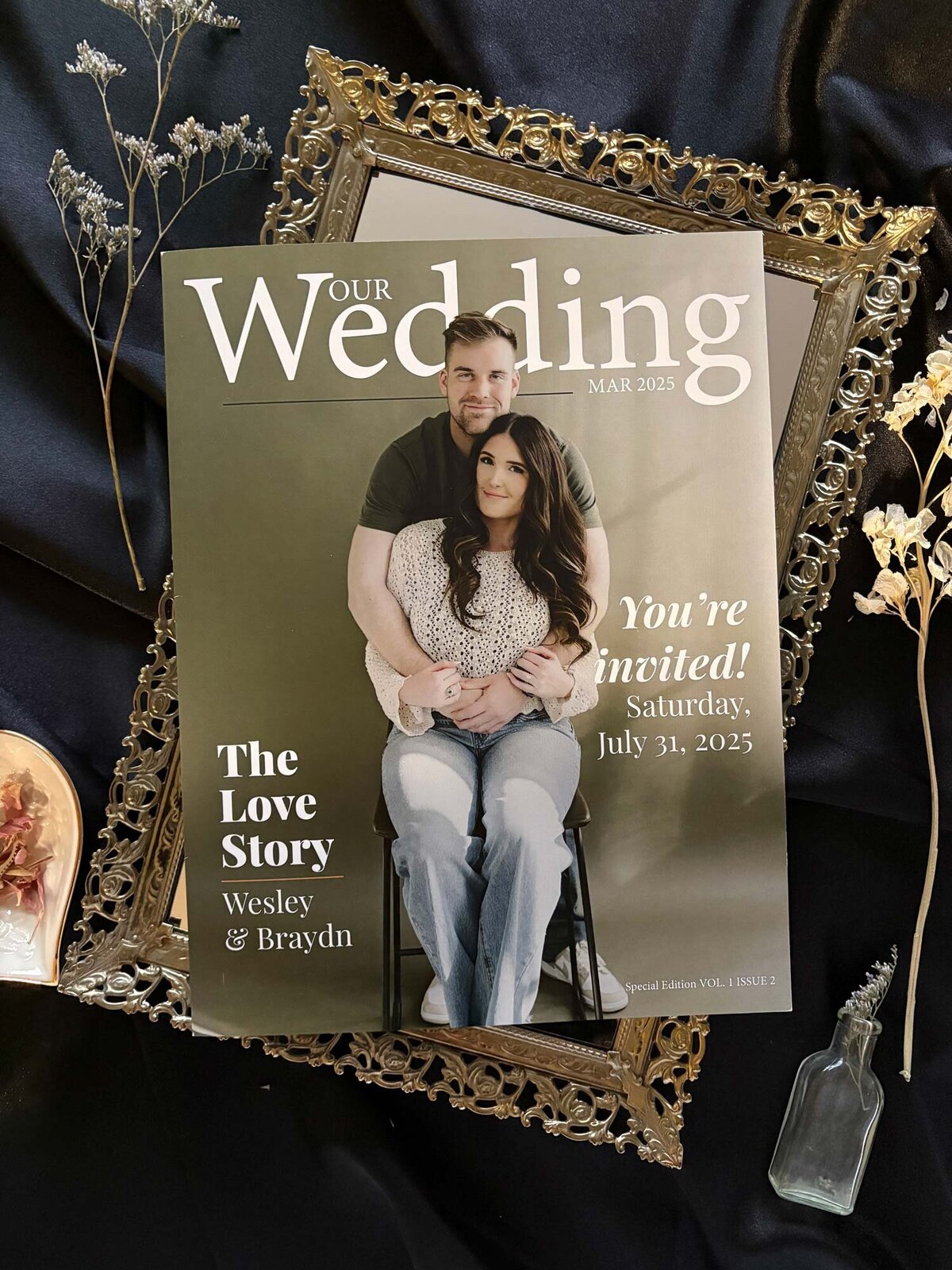 Flatlay of magazine wedding invitation cover with flowers and engagement ring