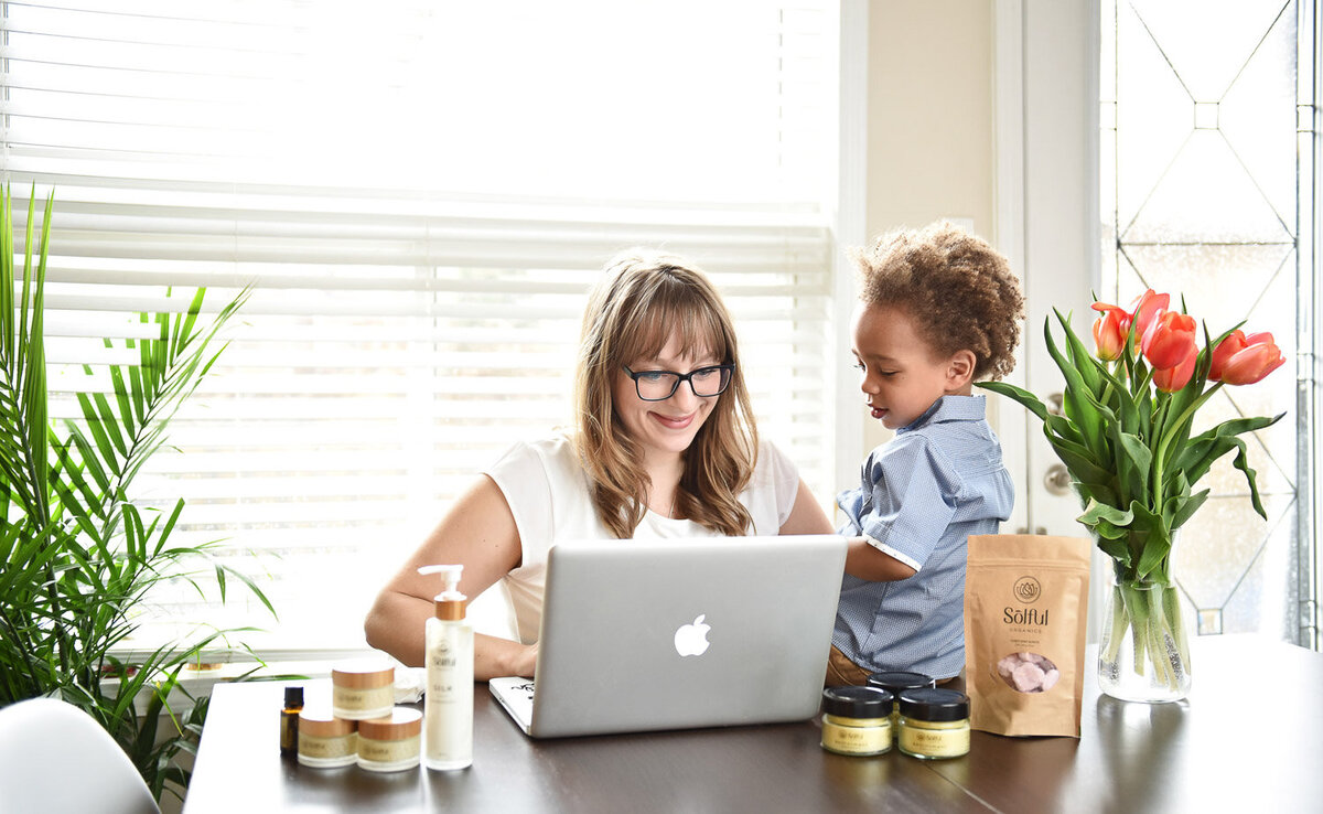 woman working with  young son watching