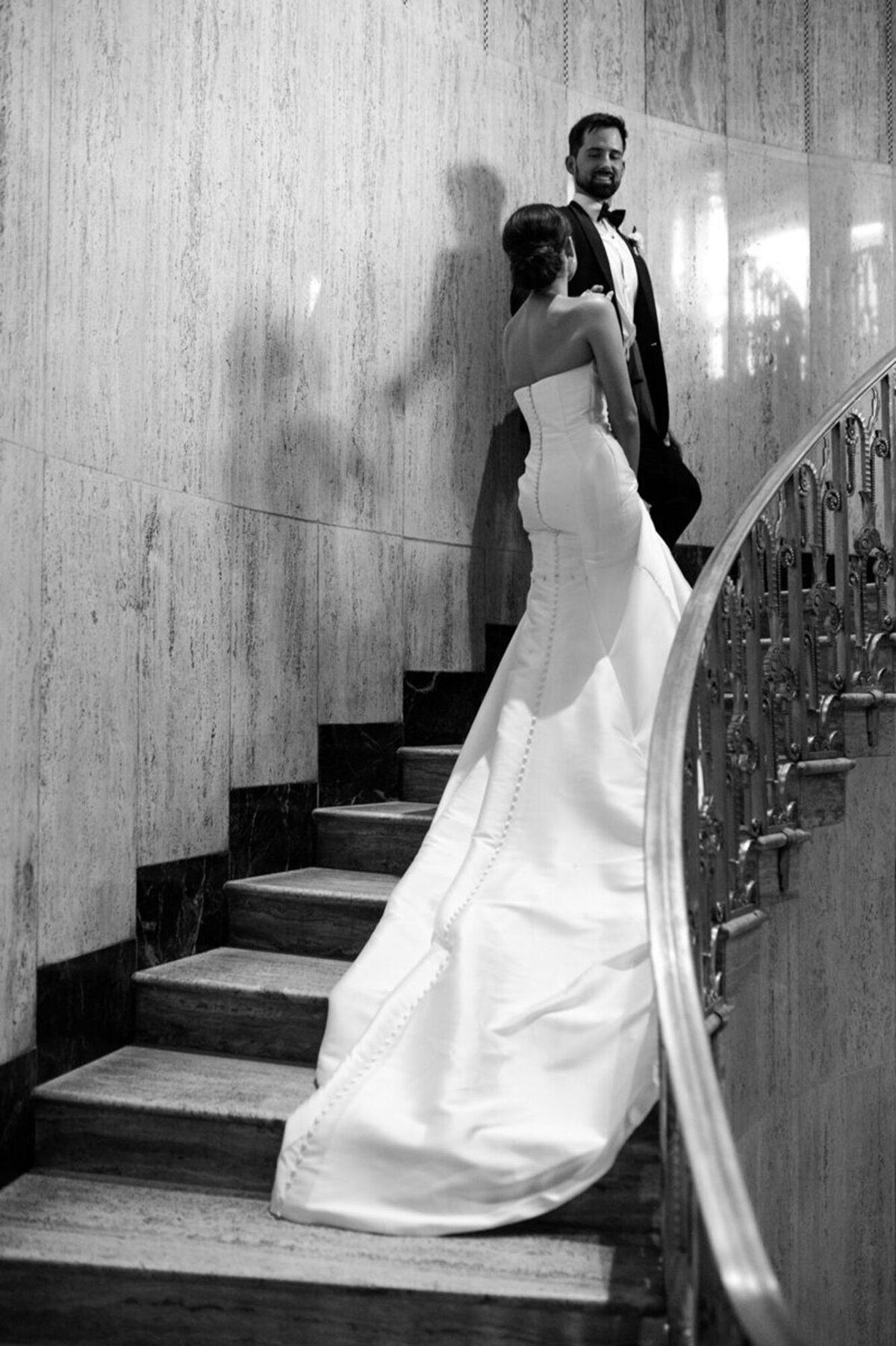 Bride and groom walking up stairs, taken by Detroit Michigan wedding photographer​ Courtney Rudicel