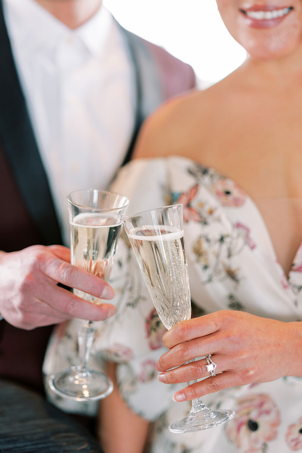Bride and groom clinking champagne flutes during a modern wedding inspiration shoot at the Kimpton Armory in Bozeman.