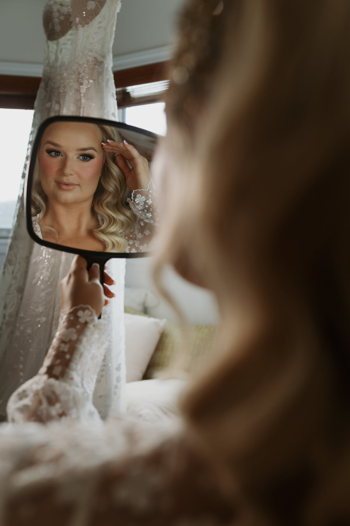 bride looking at makeup on yeg wedding morning