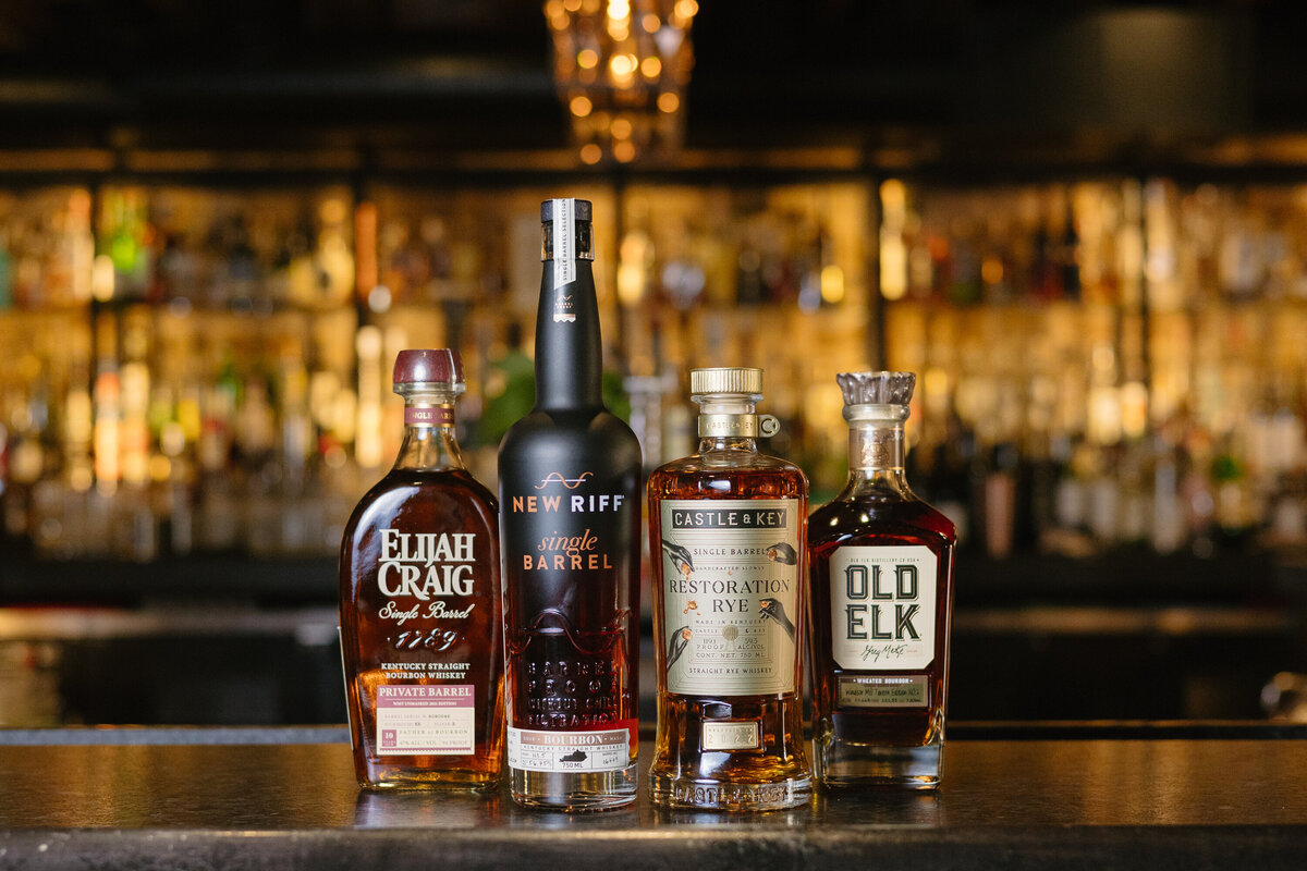 Four bottles of whiskey sit on the bar top at The Windsor Mill Tavern in Windsor, Colorado.