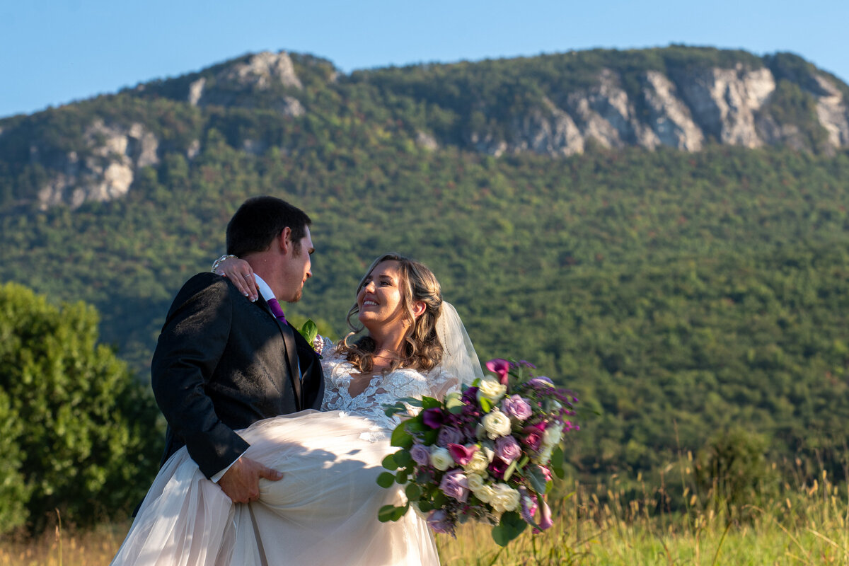 A person dipping their partner as they smile on their wedding day 