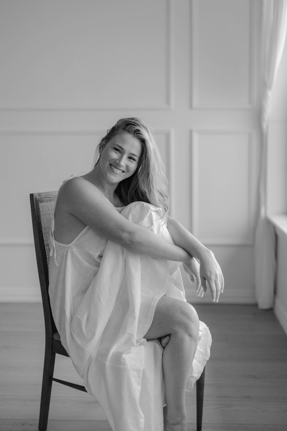 woman smiling by window