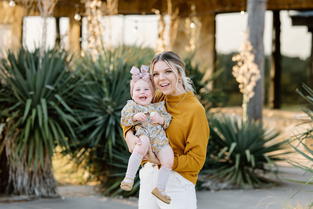 mother holding one year old daughter at El Cerrito Lodge during family pictures
