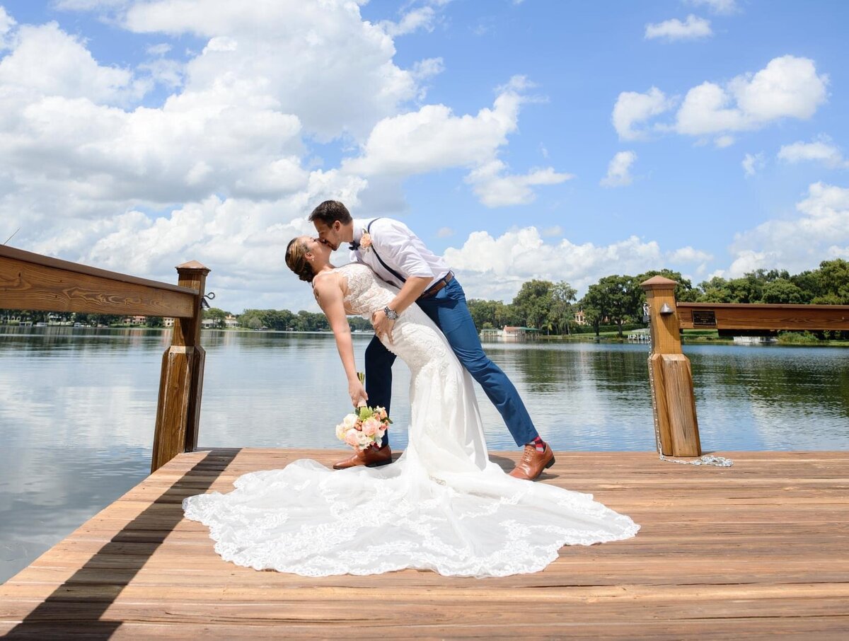 couple kissing and dip at wedding 