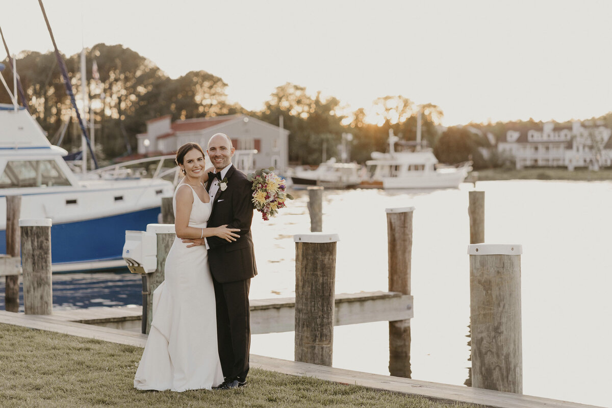 Bride and groom smiling on a dock