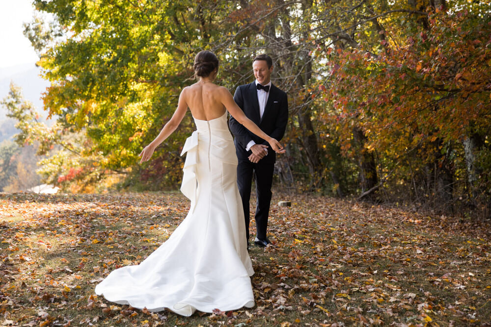 bride shows off her wedding dress to the groom and he sees her in it for the first time 