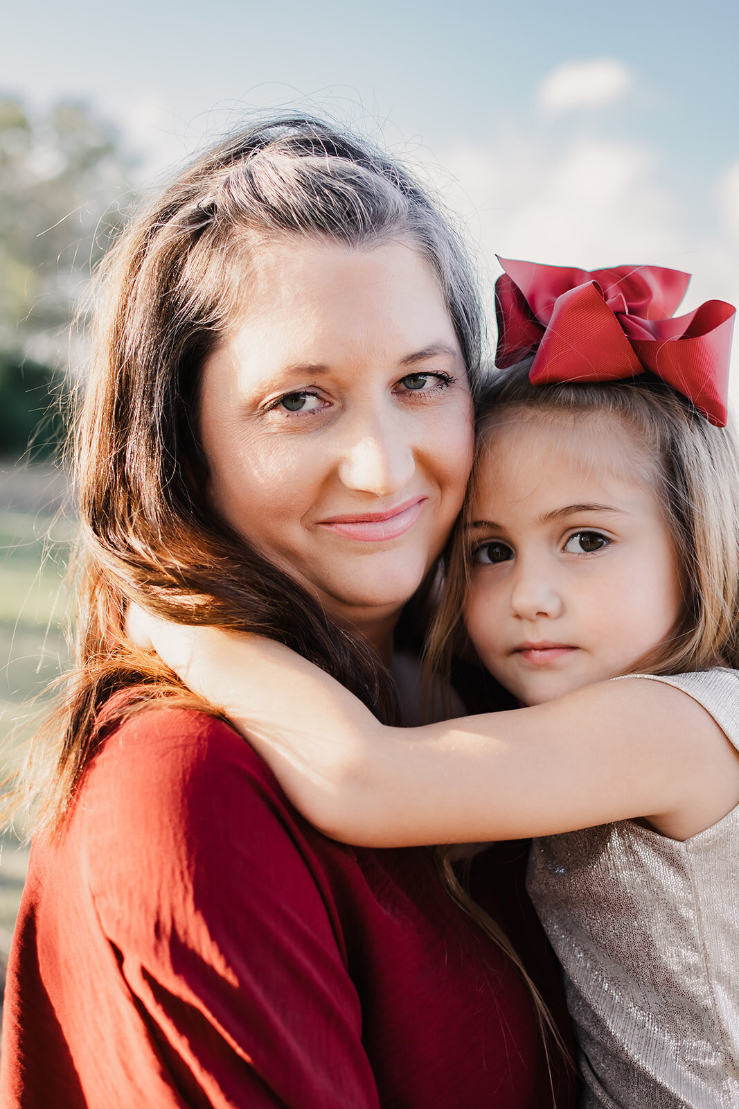Daughter wrapping her arms around her mother.