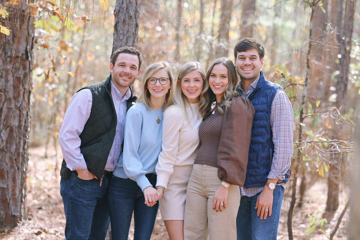 family-posing-together-in-woods