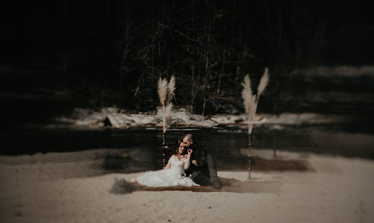 bride and groom sitting on brown mountain beach resort
