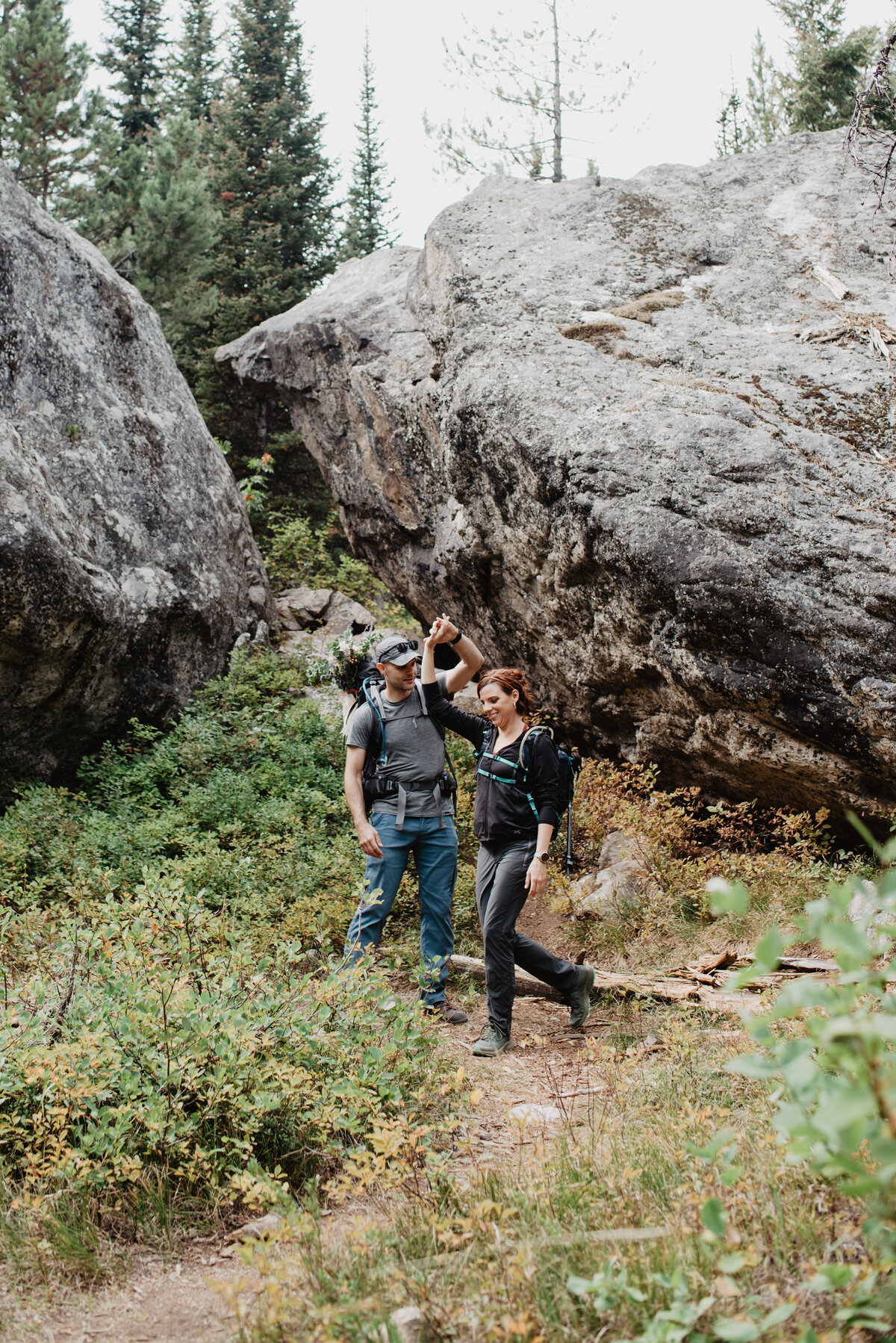 Jackson Hole photographers capture man helping woman through hike