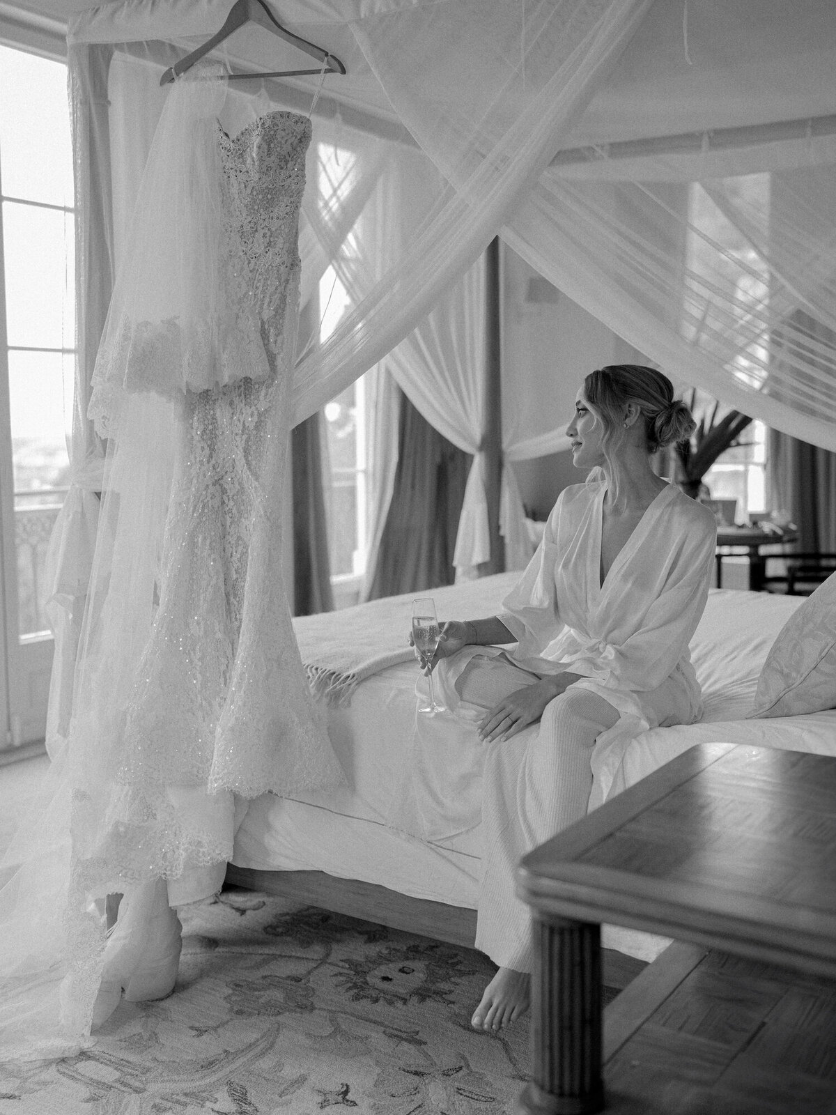 The bride is sitting in her bed before getting her dress on in her destination wedding in Quinta da Bellavista