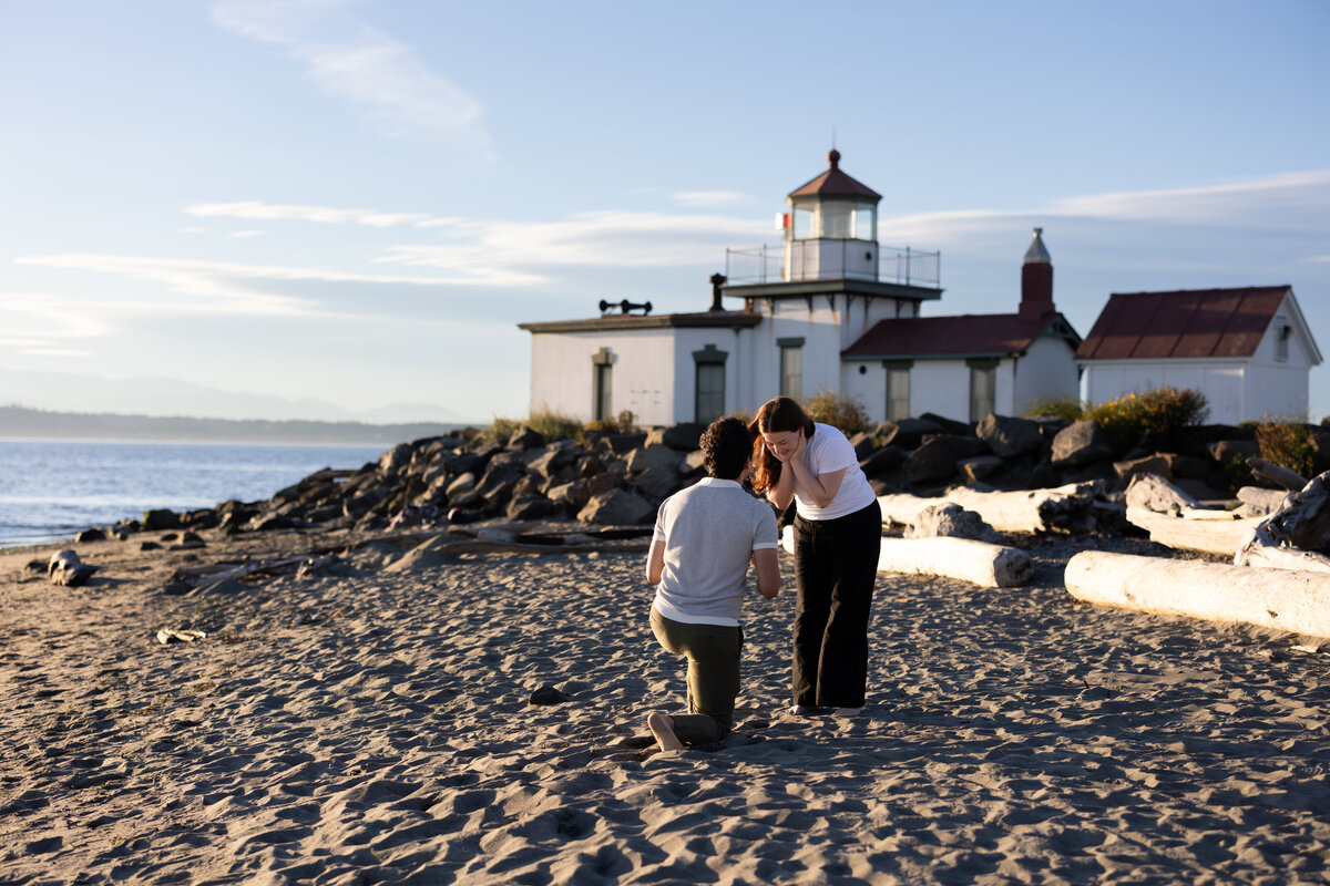 couple getting engaged on a beach in seattle washington