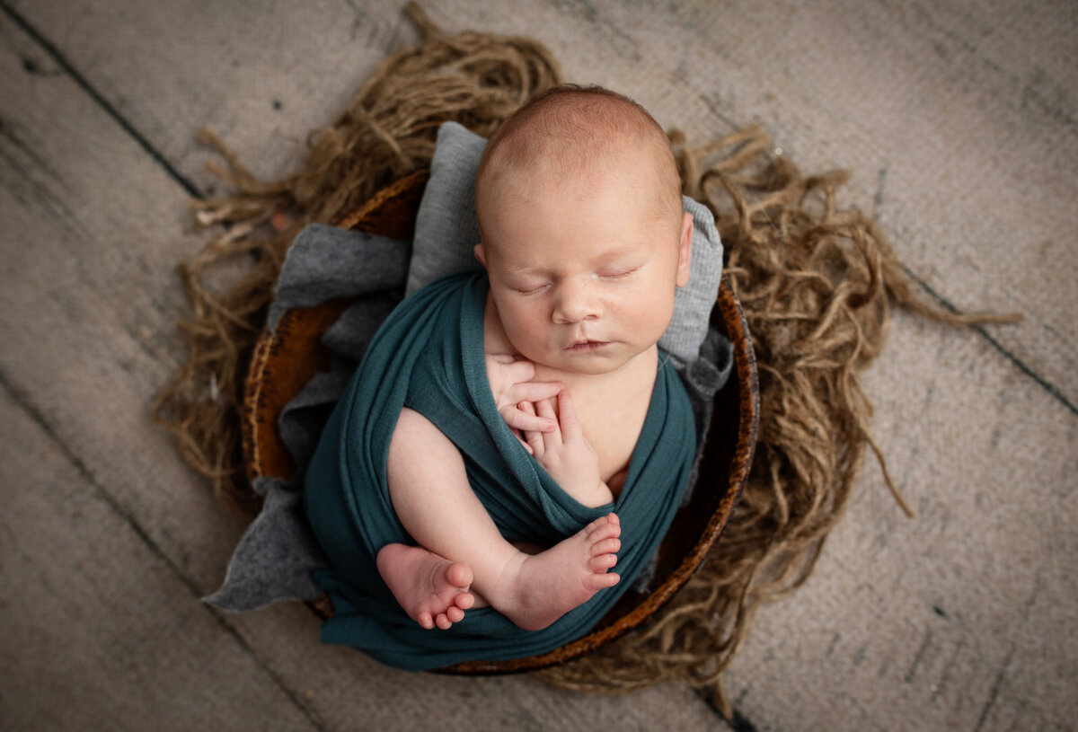 Baby boy wrapped in a swaddle, sleeping peacefully