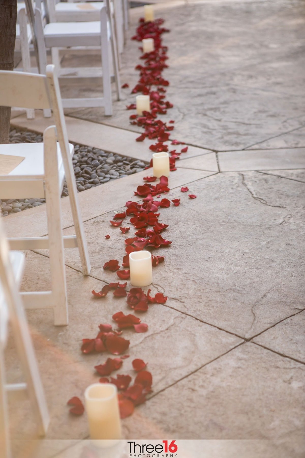 Roses and Candles line the walk way at a wedding ceremony