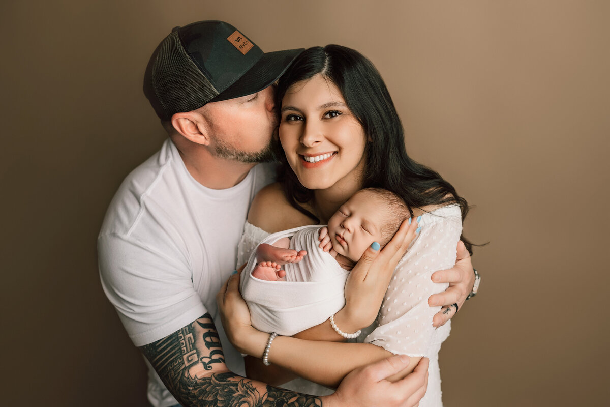 Fort Colins parents with their newborn baby boy smiling