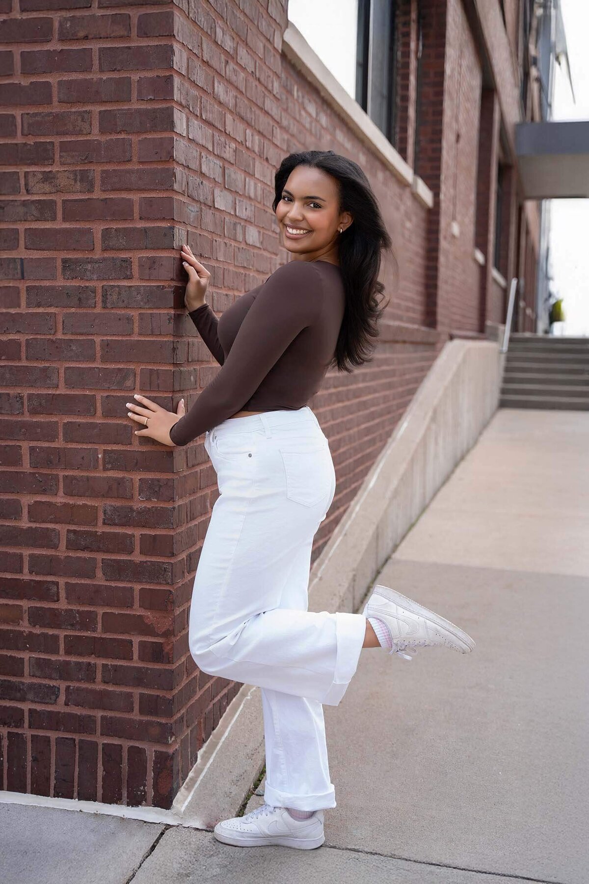 senior-girl-posed-by-brick-in-the-city