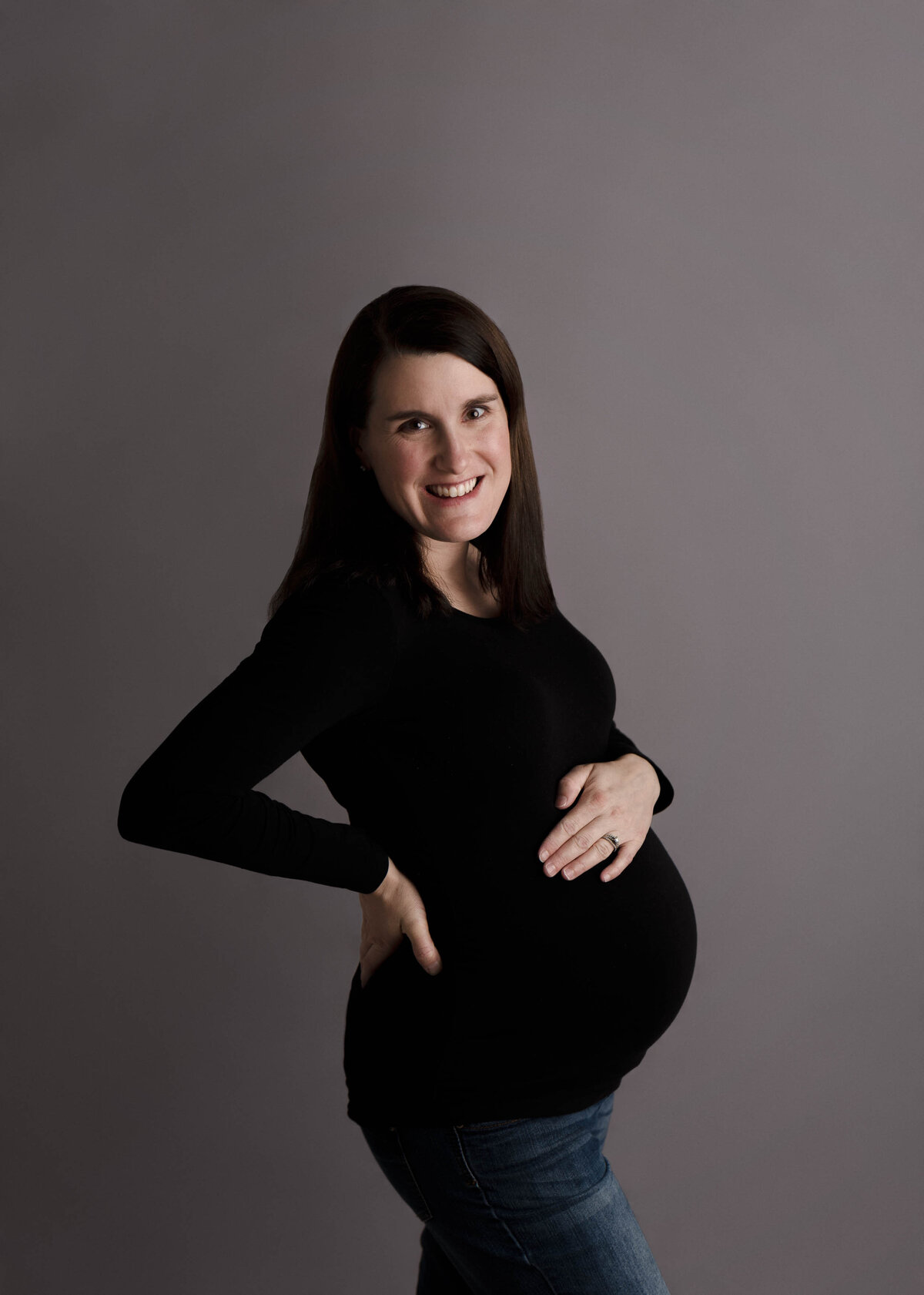 Portrait Of Pregnant Woman Standing Smiling