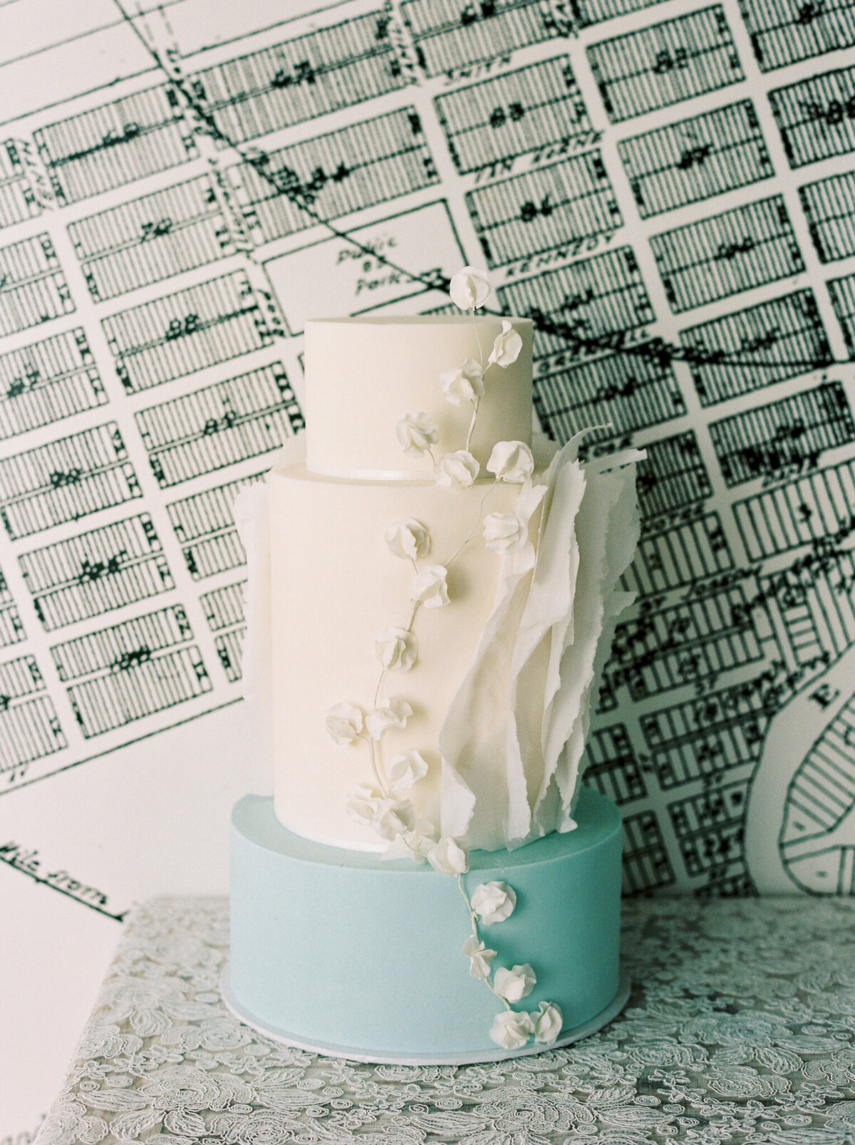 Beautifully handcrafted wedding cake with blue, teal and white tiers, and unique icing details, by Yvonne's Delightful Cakes, classic cakes & desserts in Calgary, Alberta, featured on the Brontë Bride Vendor Guide.