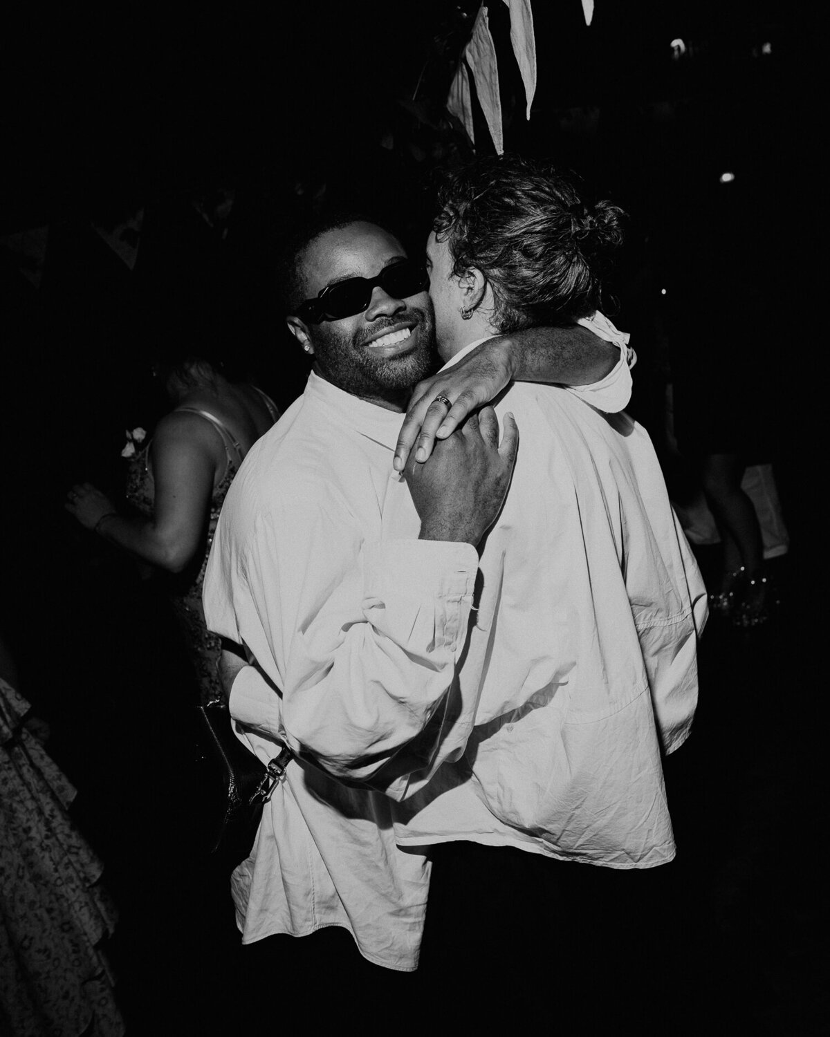 An LGBTQ+ couple dance at a wedding in London. 