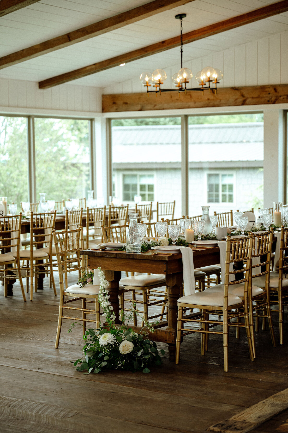 image of a reception setting with tables and gold chairs