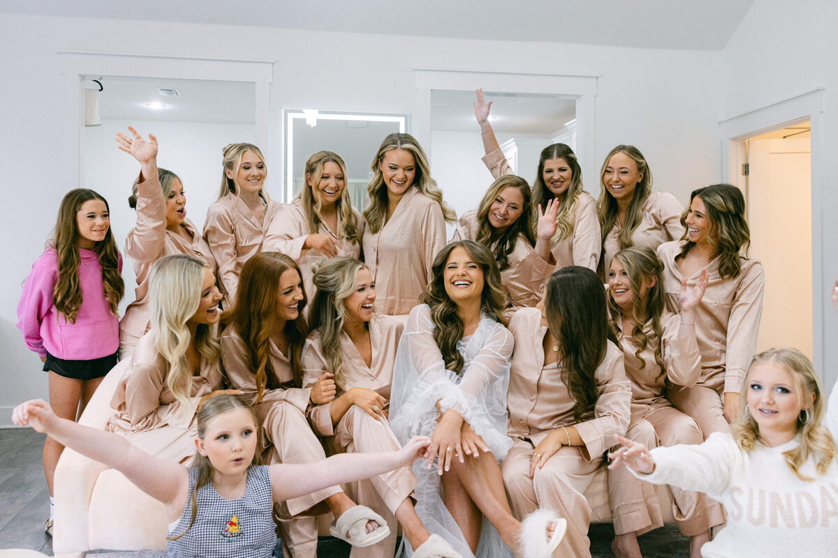 A wedding picture of the bride and her bridesmaids celebrating