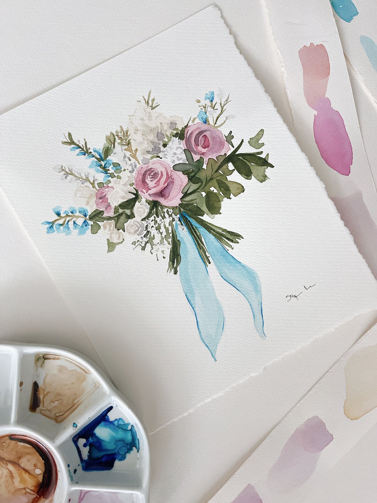 Delicate watercolor floral bouquet illustration with blue ribbon, showcasing Stephanie Anne Illustration's elegant wedding artwork style from Montreal