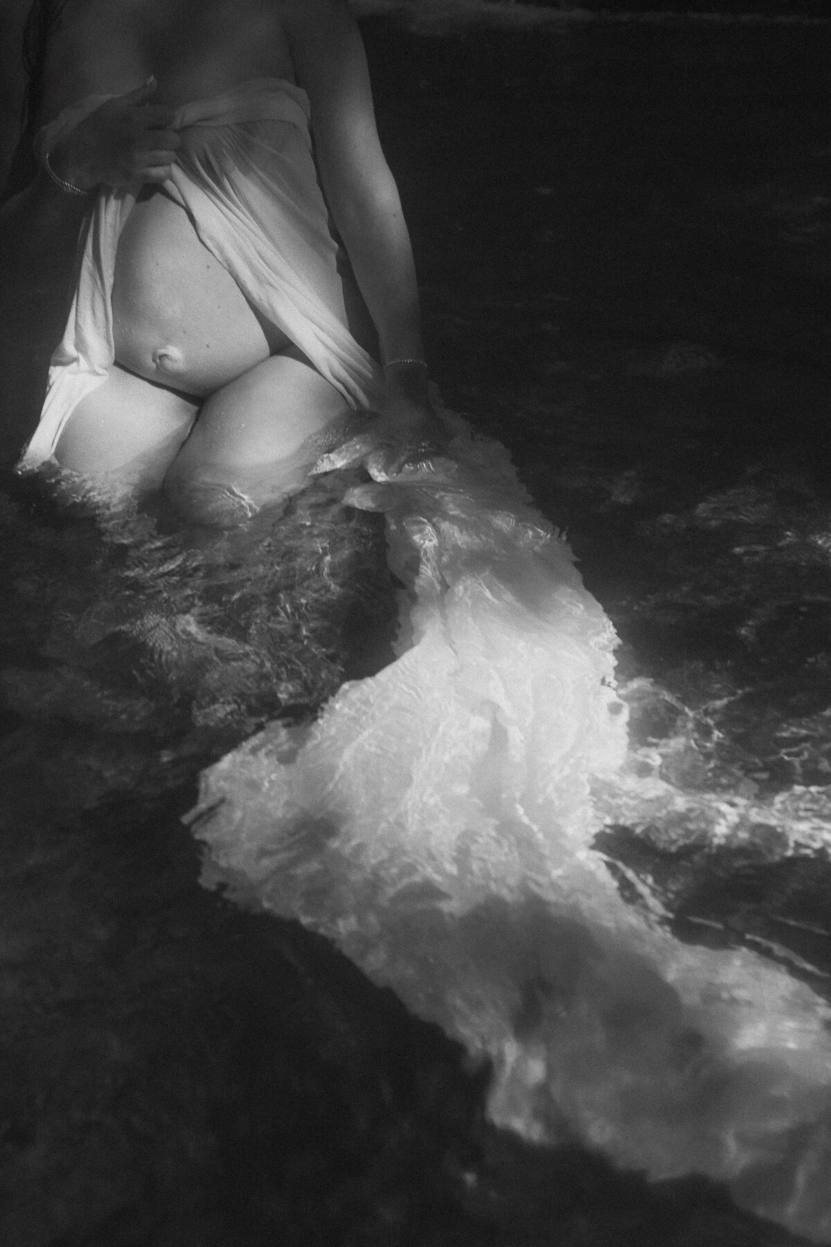 Black and white maternity photo in water
