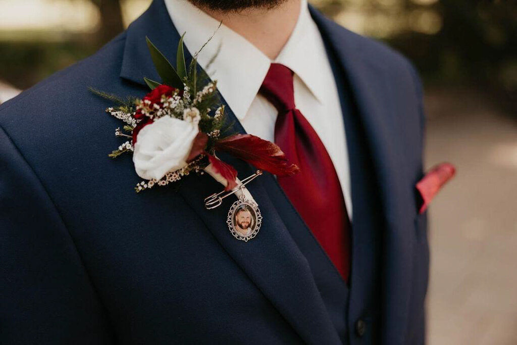 White and red groom boutonniere by Bloomdigity Floral Studio, an contemporary, Lethbridge, Alberta wedding florist, featured on the Brontë Bride Vendor Guide.
