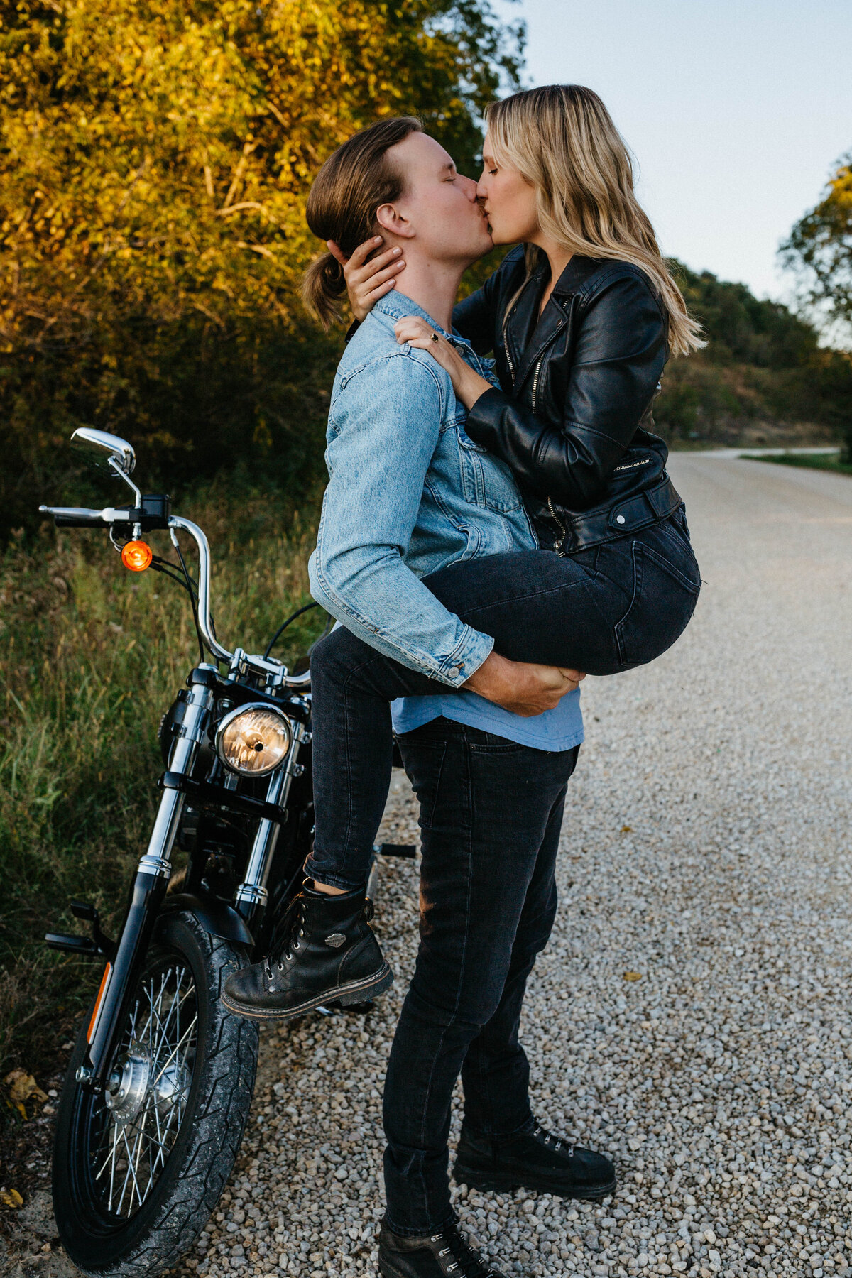 engaged-couple-kissing-by-motorcycle