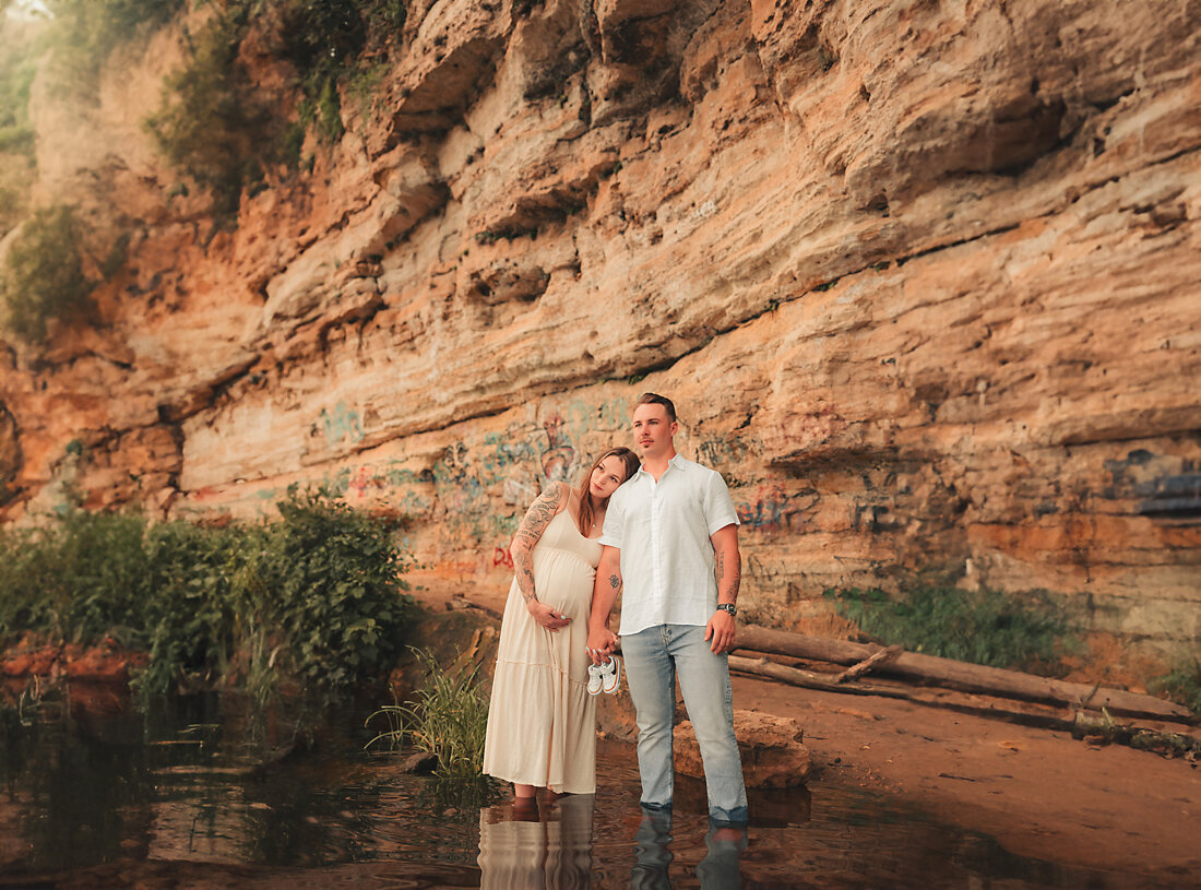 A serene maternity portrait captured by the tranquil lakeside in Stillwater, MN, showcasing a mother’s calm anticipation and natural beauty