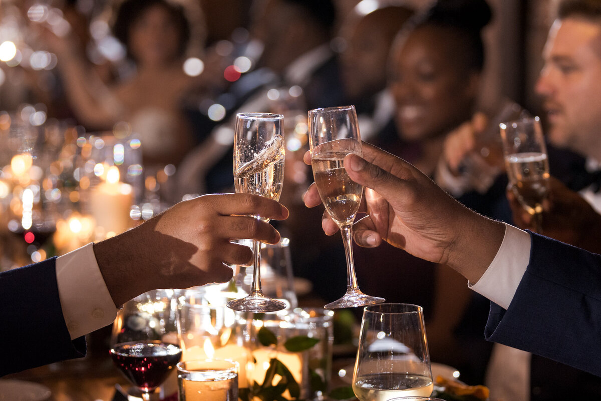 Wedding guests clink champagne flutes after a toast at Ovation in Chicago, IL