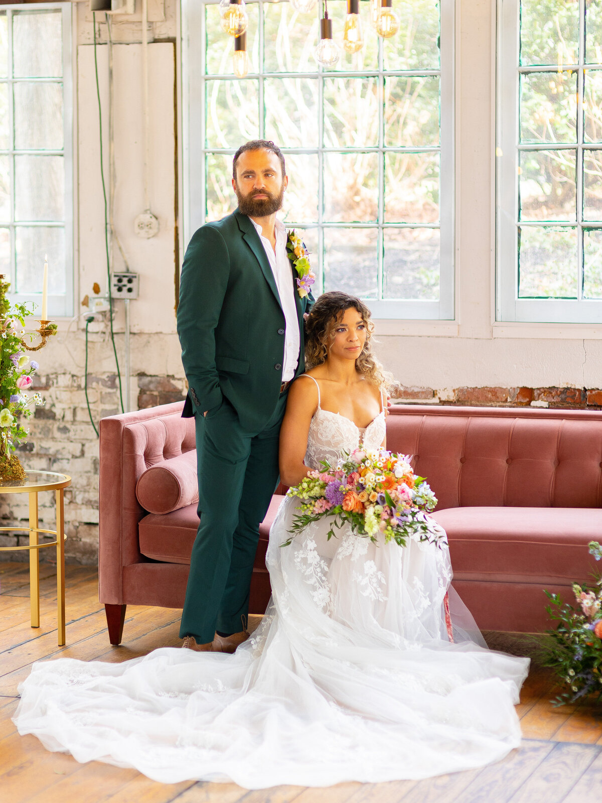 Bride sitting with groom stnading behind her