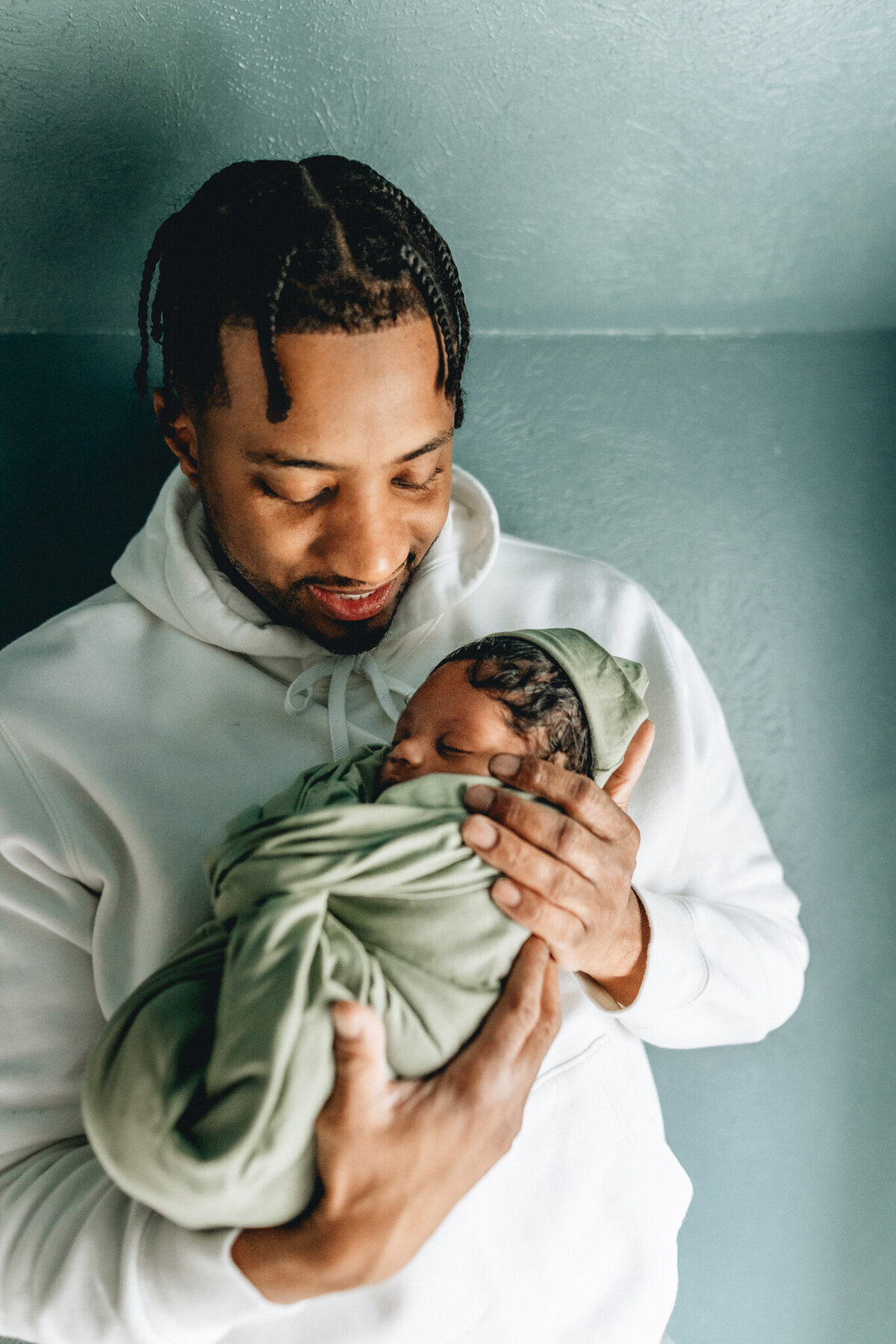 Family photography of dad holding newborn baby