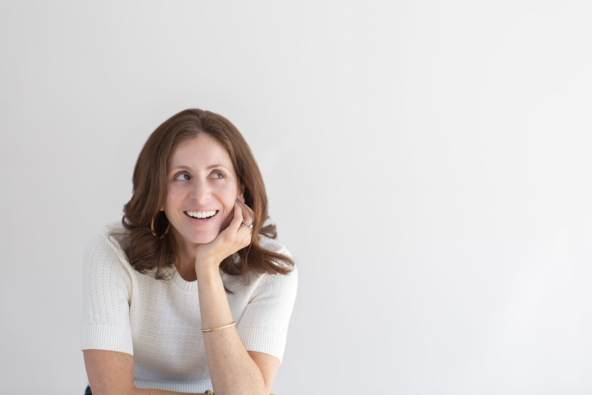 Fun and relaxed headshot of a woman laughing with joy