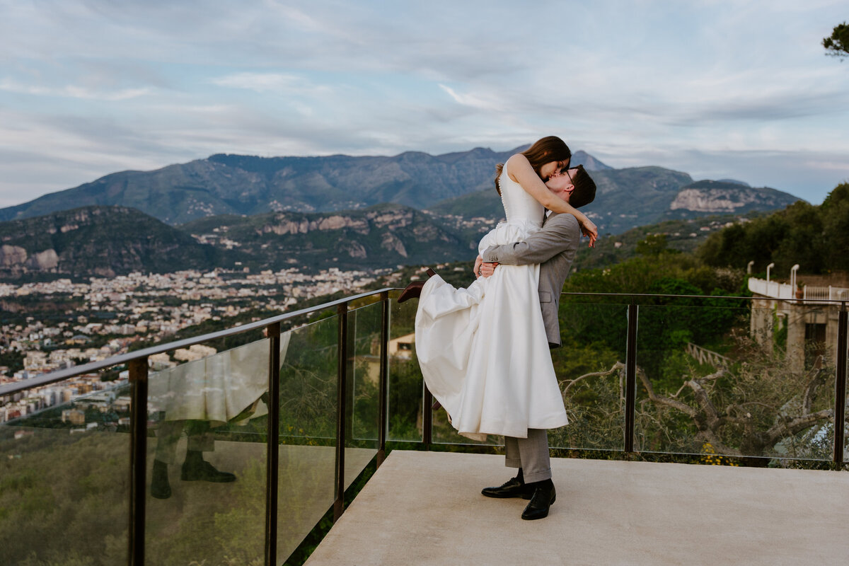 Couple hugging on Sorrento terrace at sunset