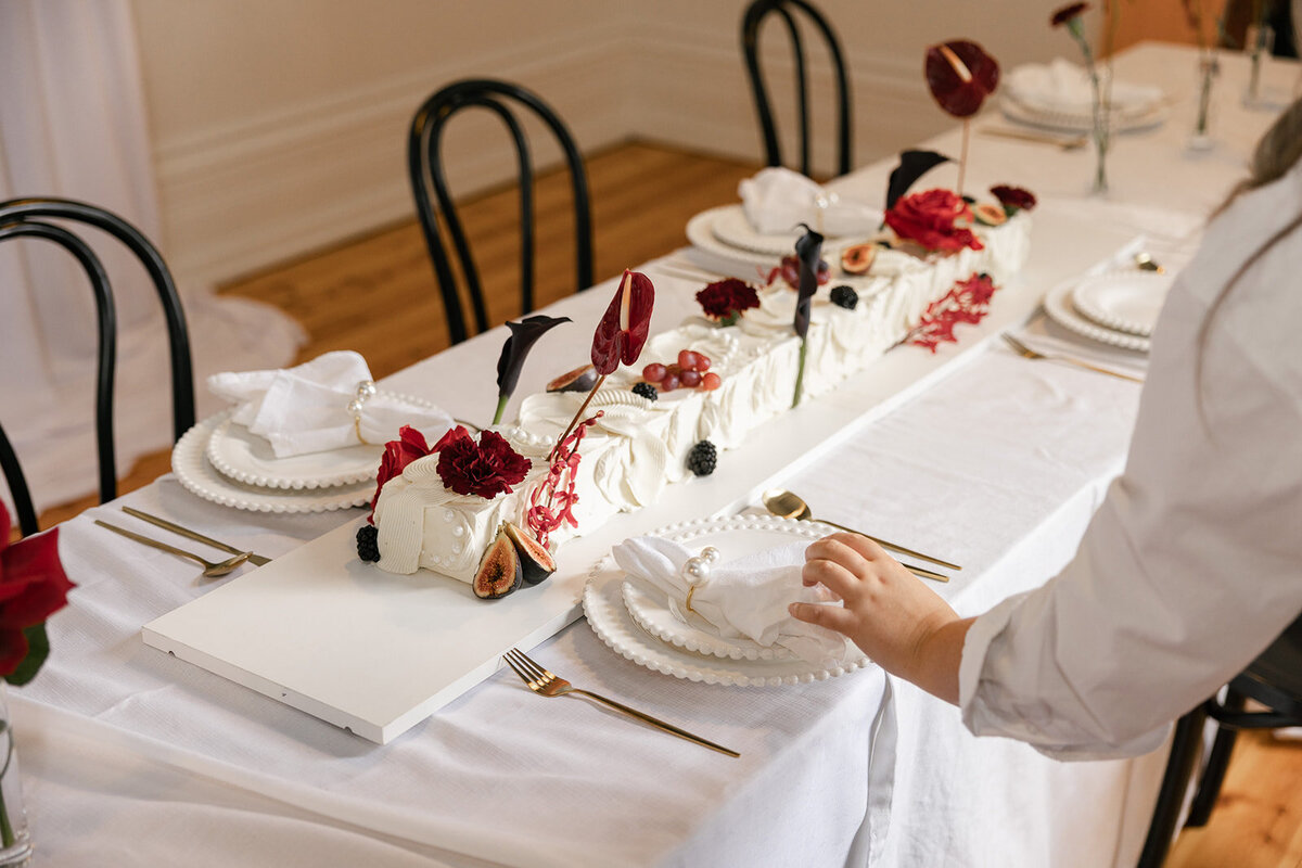 Personalised Wedding table at a wedding reception. Styled with romance, deep reds, pearls and gold in mind.