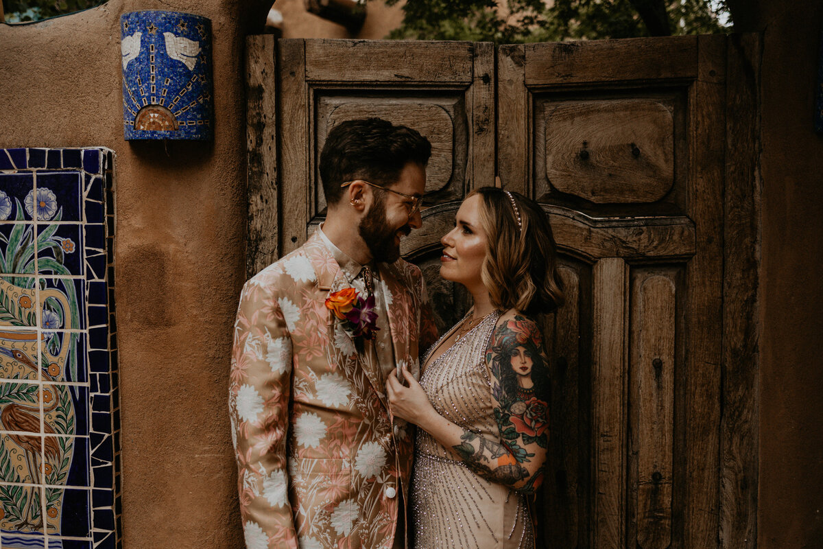 eloping couple holding each other in colorful wedding attire