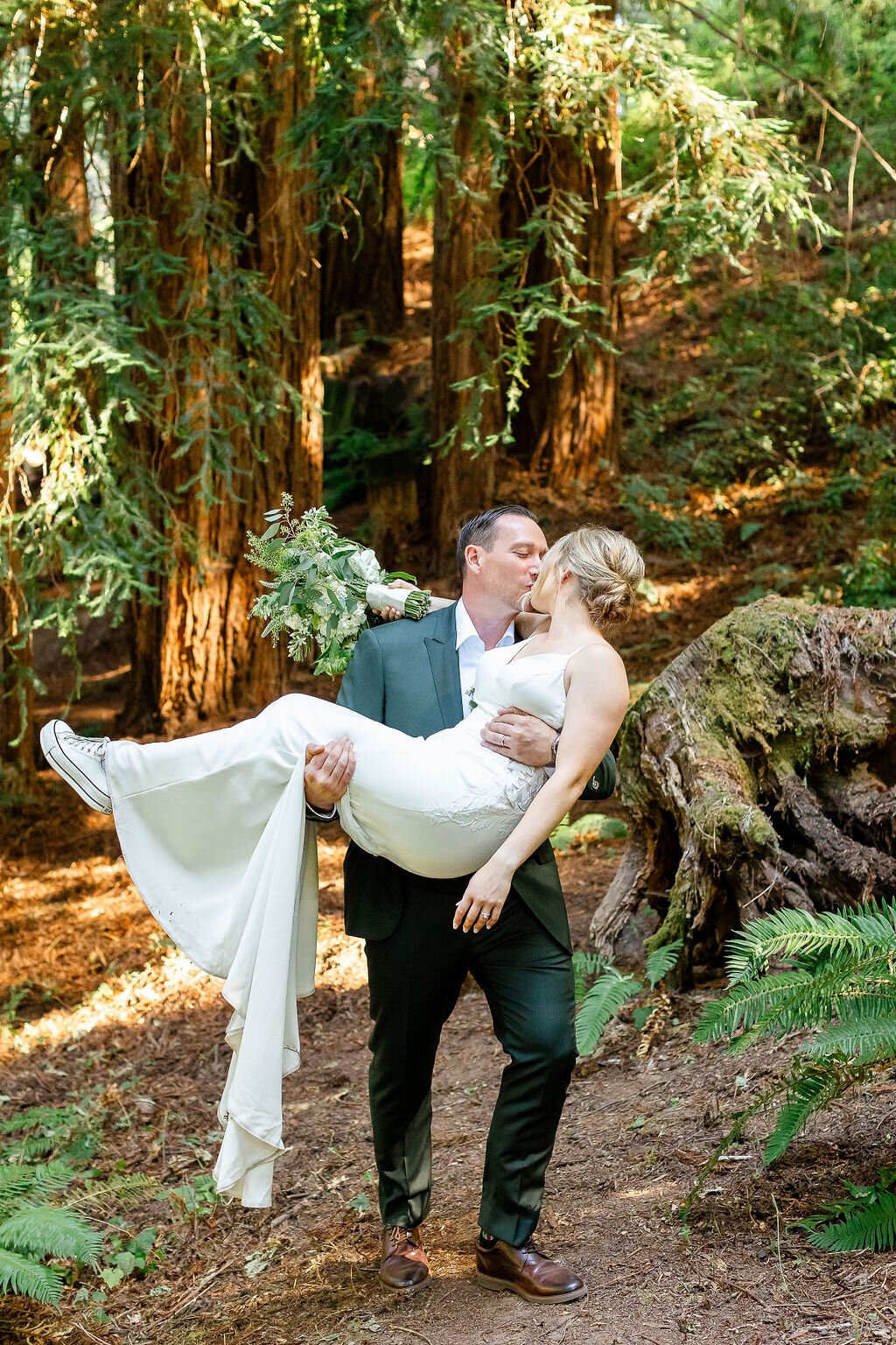 Groom kissing his bride in a beautiful garden