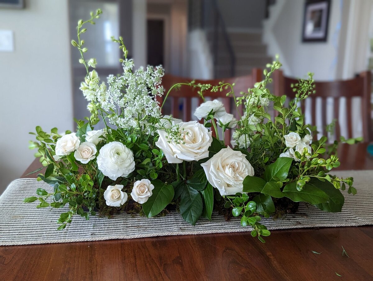 white funeral flower arrangement casket
