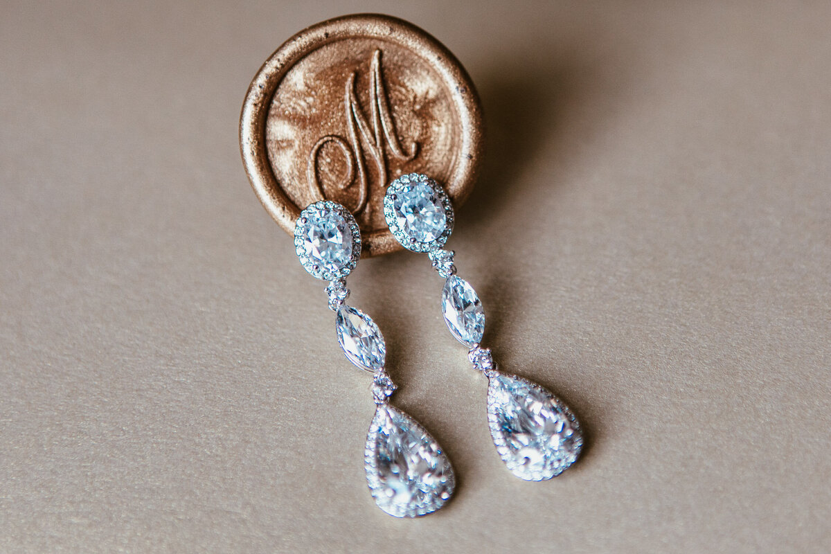 Diamond earrings with metallic gold wax stamp