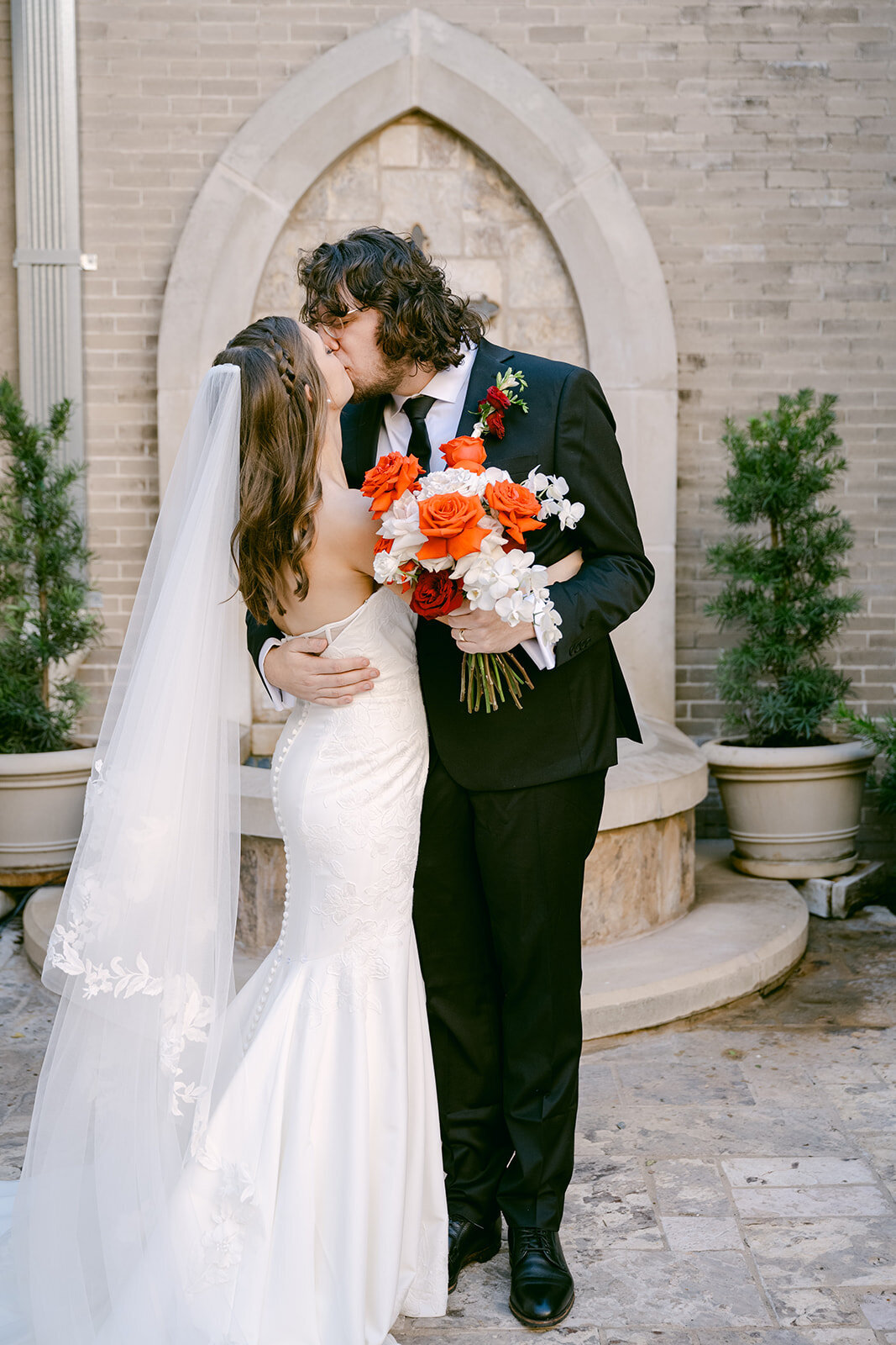 Bright floral bouquet and couple portrait styled for editorial feature outside Texas luxury wedding venue