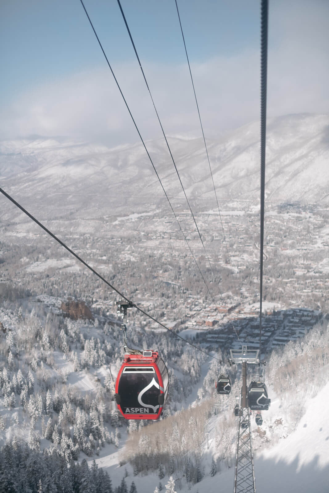 View of Aspen from the gondola ski lift showcasing a snowy town beneath the St. Regis Aspen wedding venue.