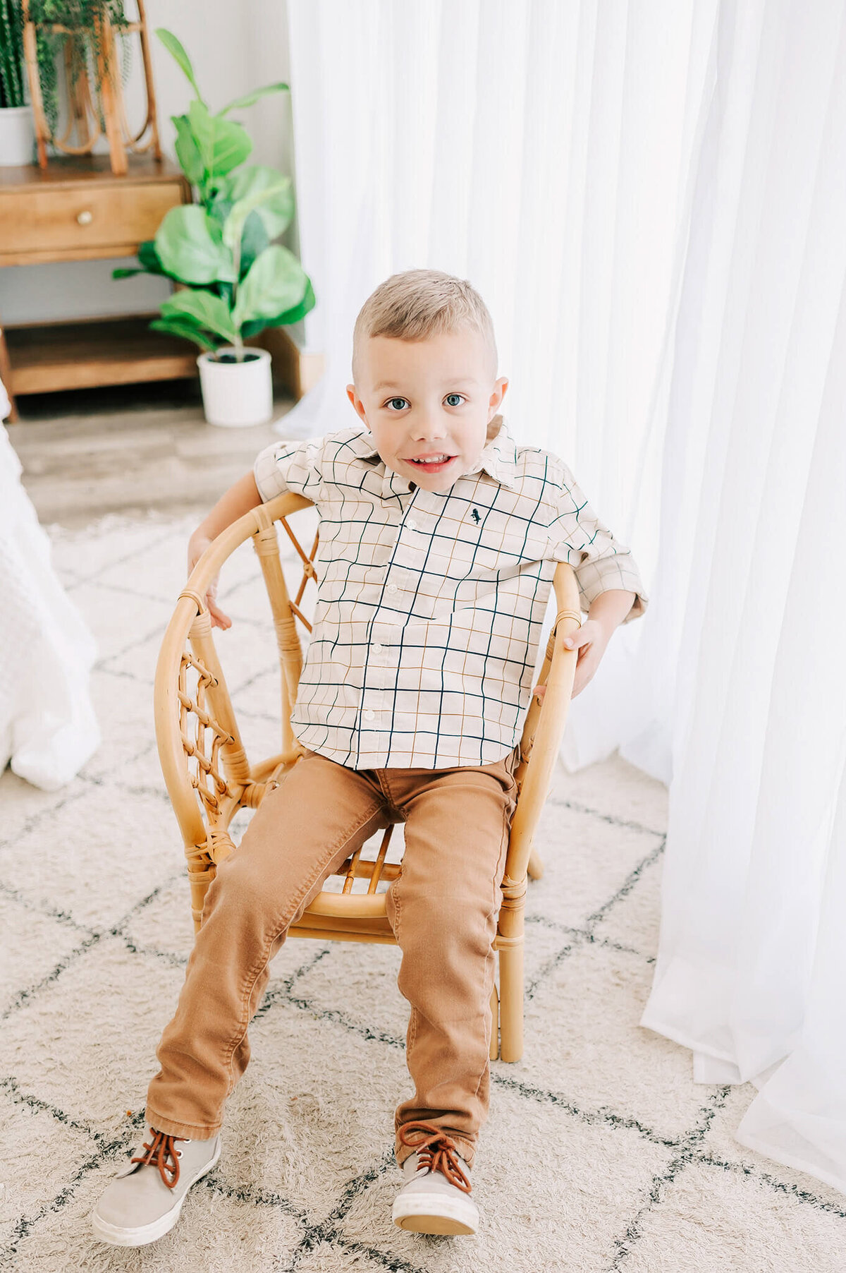 little boy slouching in chair in Branson family photography studio