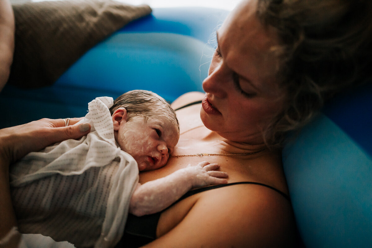 A close-up image of the baby’s face just moments after birth, capturing the awe and wonder that comes with new life.