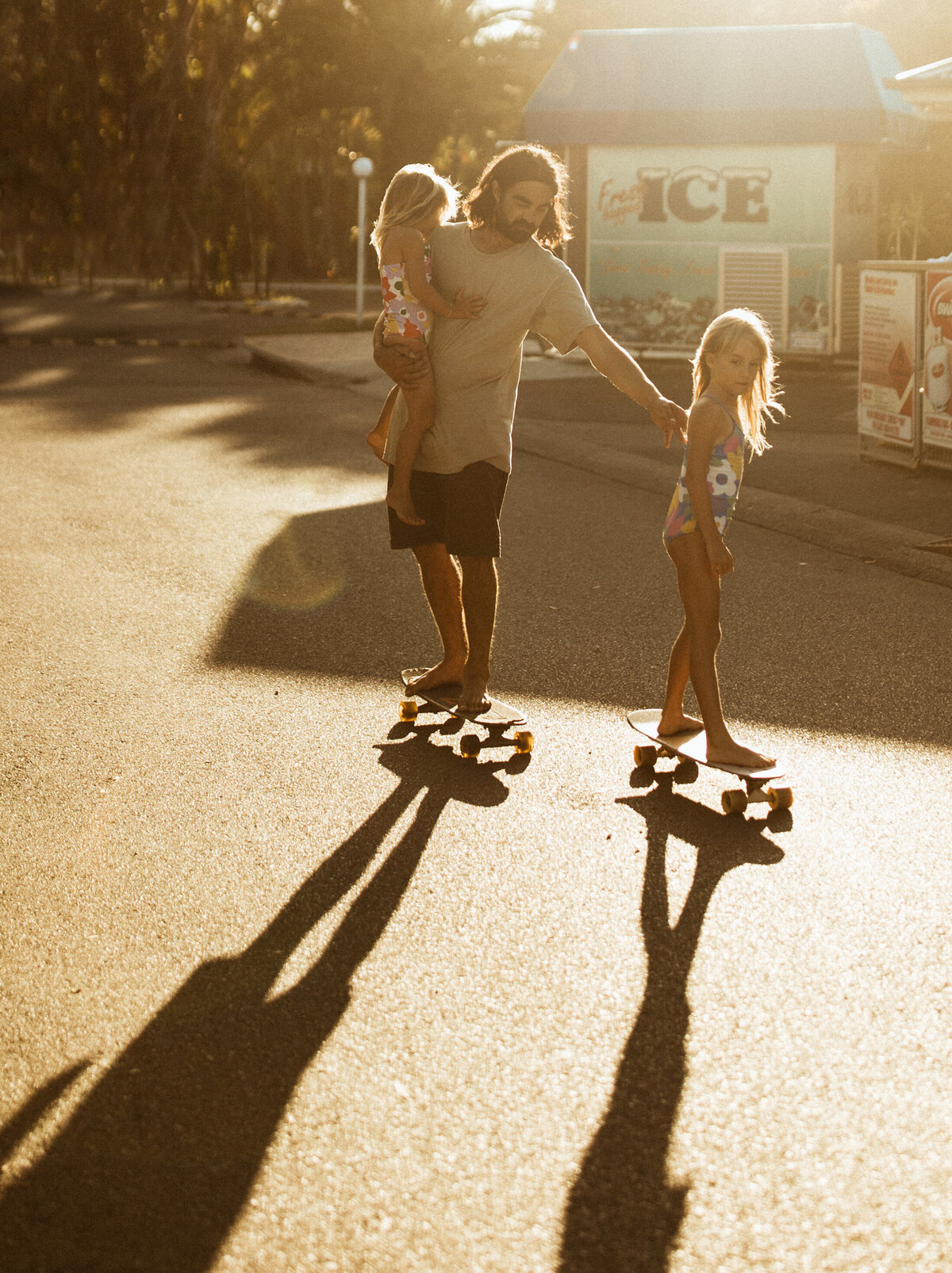 Sunset family photography father with daughters skating at one mile caravan park