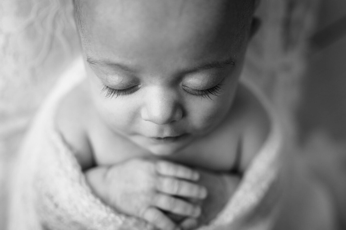 black and white detail images of a newborn girls eyelashes