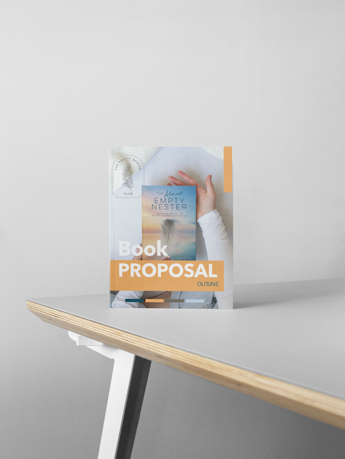 custom book proposal design sitting on top of grey desk in front of grey walls by Sweet Pea Ink Creative | Brand Design
