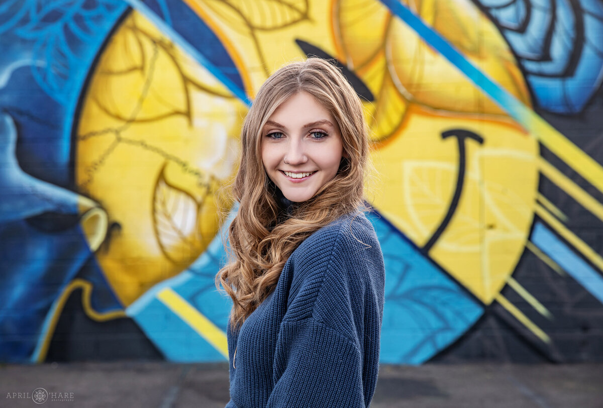 Fun Yellow and Blue Street Art Mural Backdrop for a Senior Photo in Denver